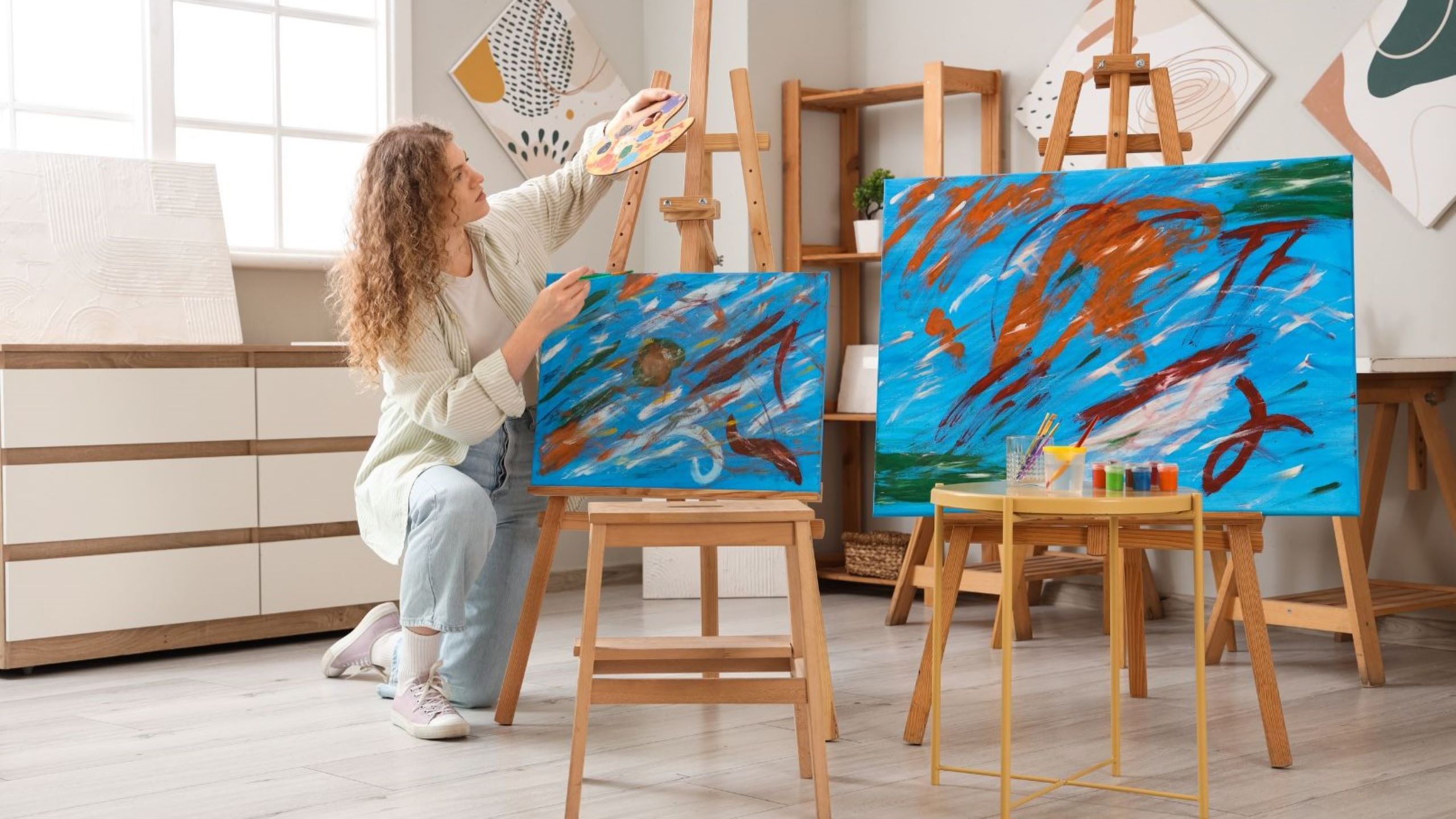 Artist painting on canvas in bright Dubai art studio art workshops creative studio classes painting