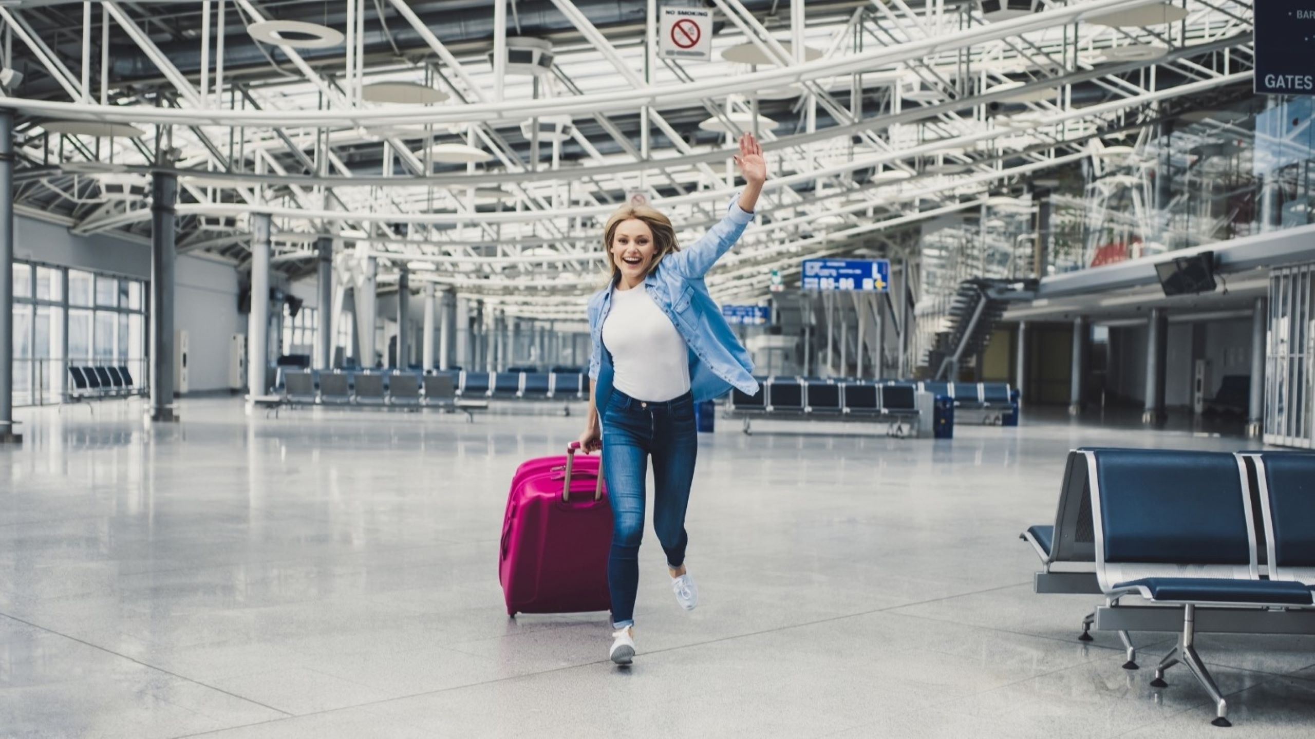 Traveler with suitcase at Dubai airport departure gate weekend escapes flight adventure travel destination