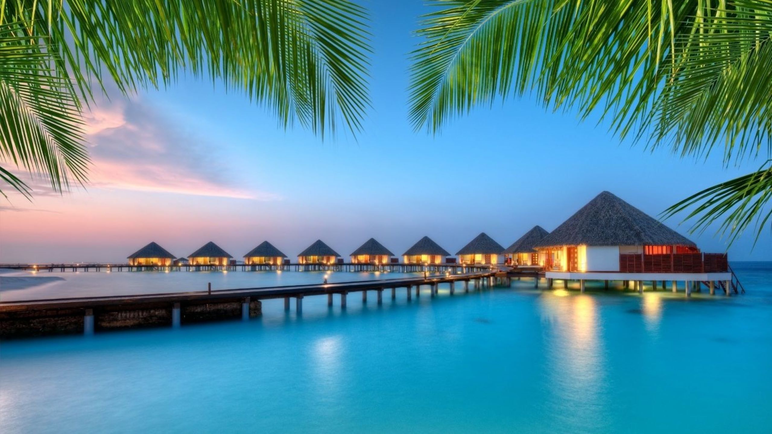 Luxury Maldives beach resort with New Year fireworks over ocean, representing perfect tropical escape from Dubai for 2025-2026 celebrations with pristine beaches and island paradise experiences