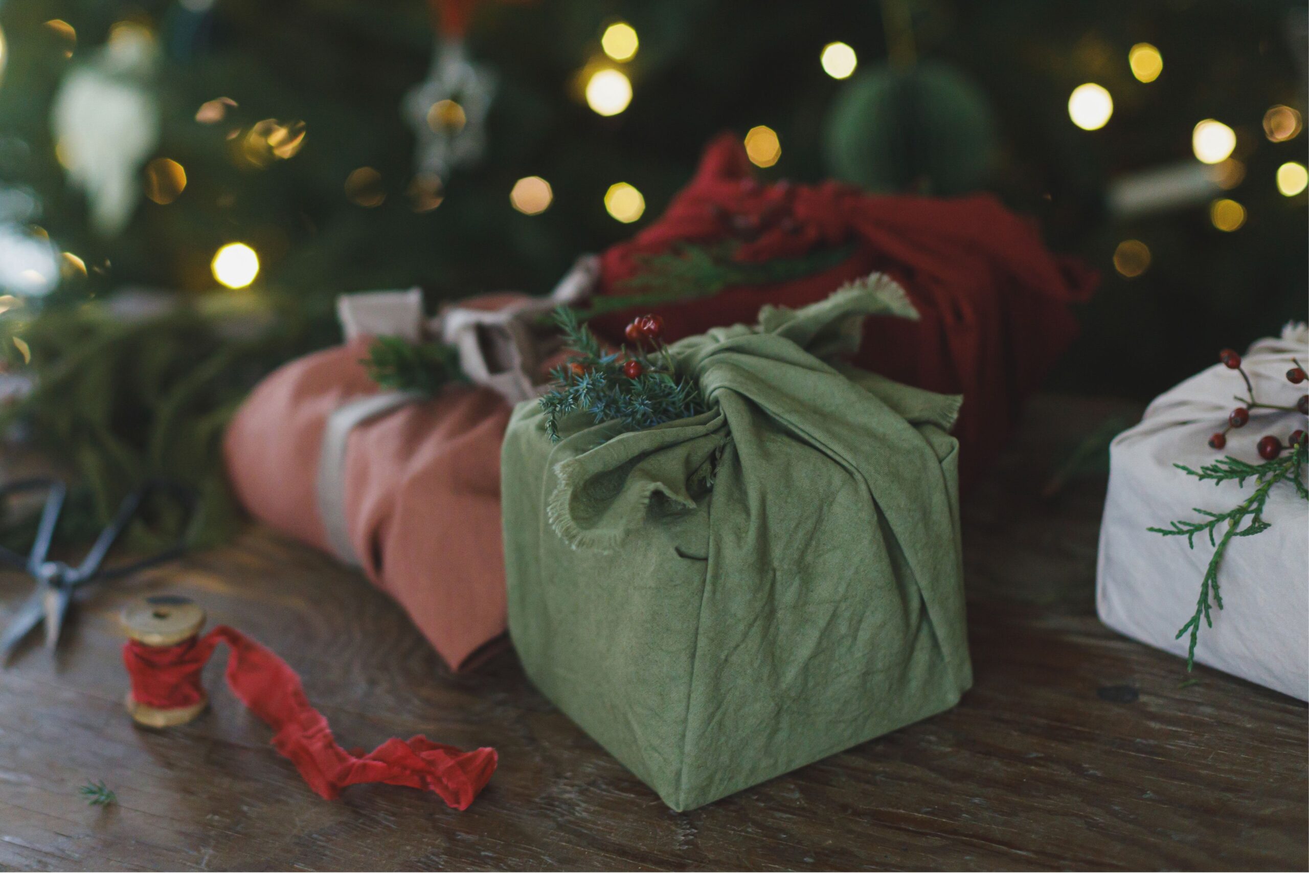 Sustainable Christmas gifts beautifully wrapped in recycled and eco-friendly organic fabric