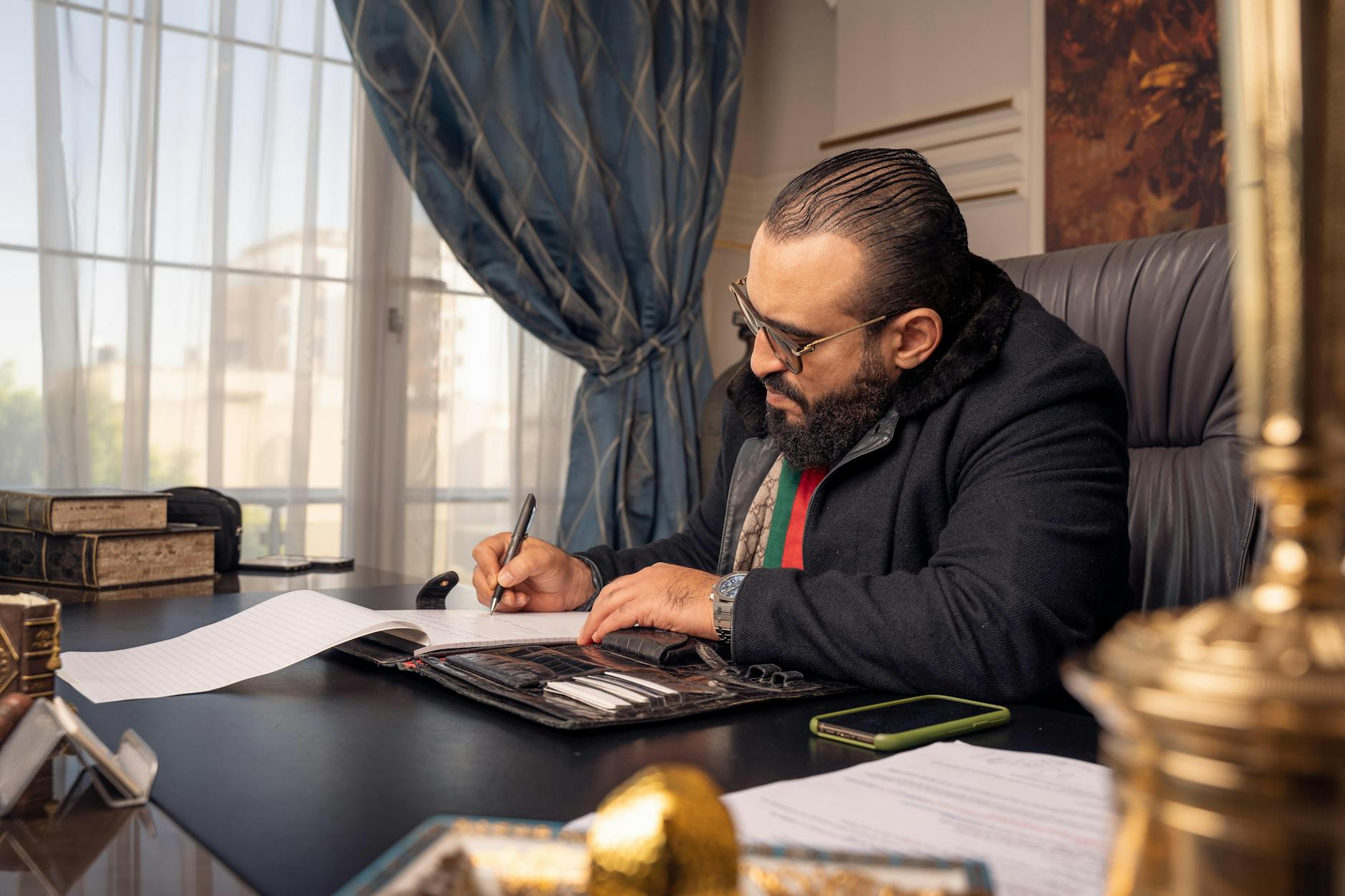 A Dubai startup founder reviews the Islamic New Year business calendar at his office desk in DIFC