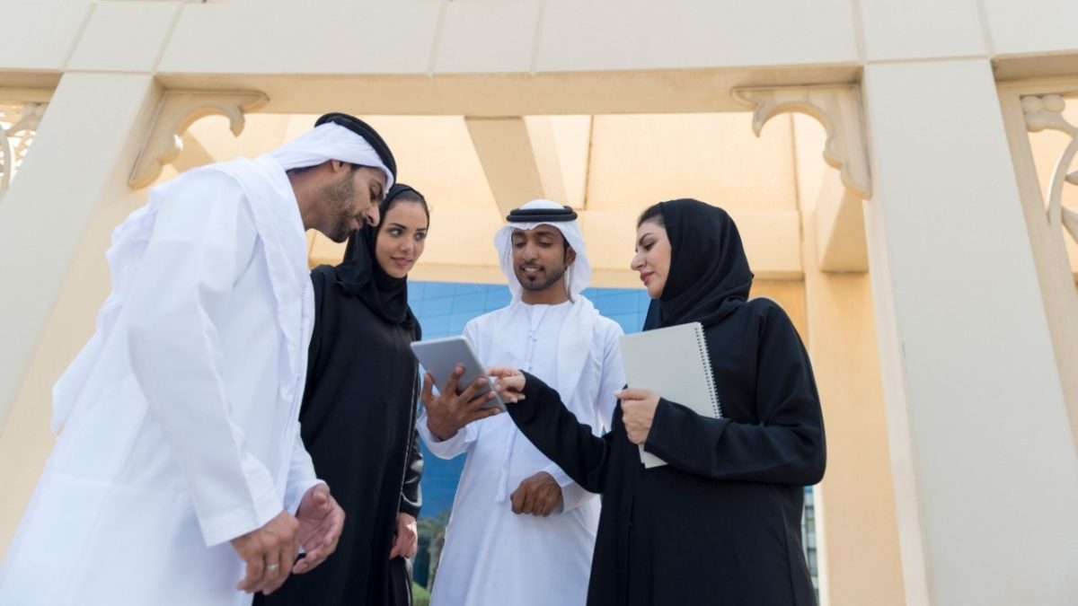A startup founder completes free zone registration paperwork at a modern Dubai business center
