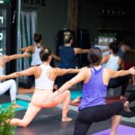 A group of women in an indoor yoga studio class in Dubai, a popular way to stay active when outdoor exercise is not possible