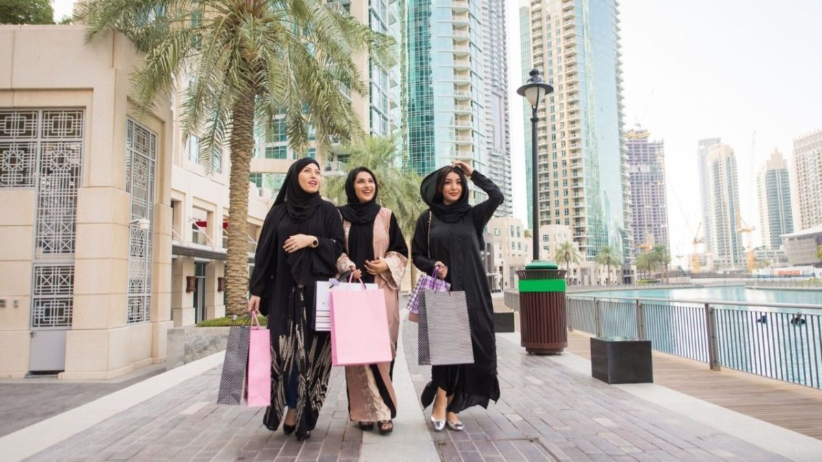 ladies exploring deals inside a Dubai mall during Dubai Summer Surprises, surrounded by colourful festival promotions.