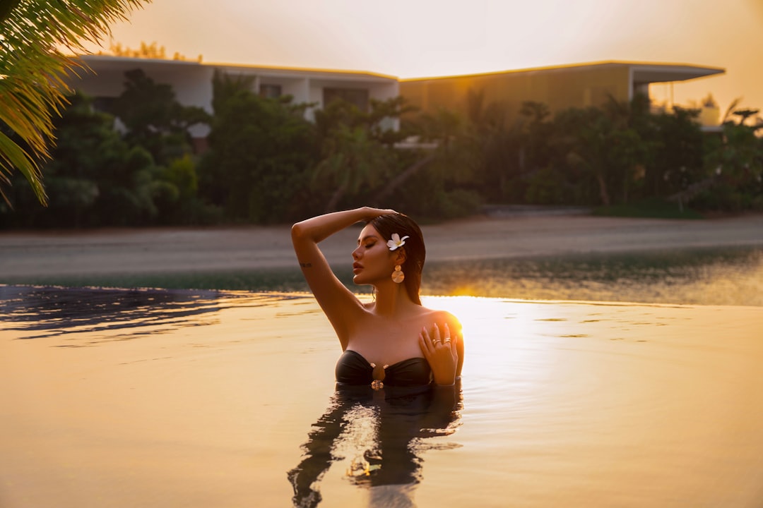 A woman relaxing by a luxury hotel pool during a Dubai staycation in summer