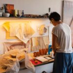 A painter works in a sunlit studio space during one of the art residencies available to Dubai residents this summer