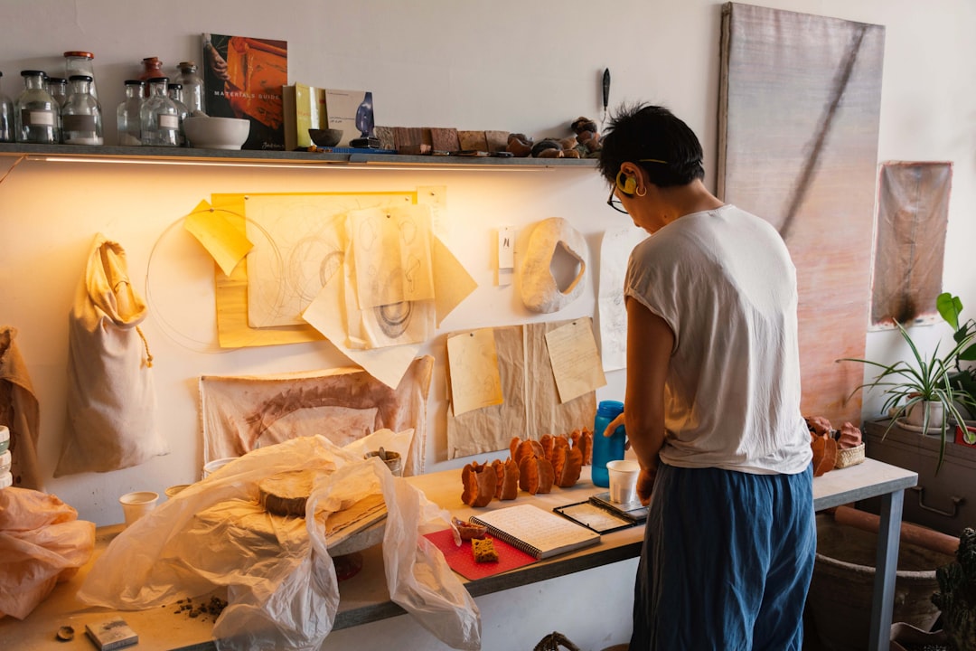 A painter works in a sunlit studio space during one of the art residencies available to Dubai residents this summer