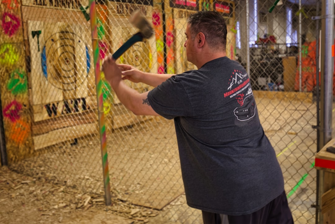 A focused player steps up to the oche at a Dubai darts tournament, with a cheering crowd visible behind him