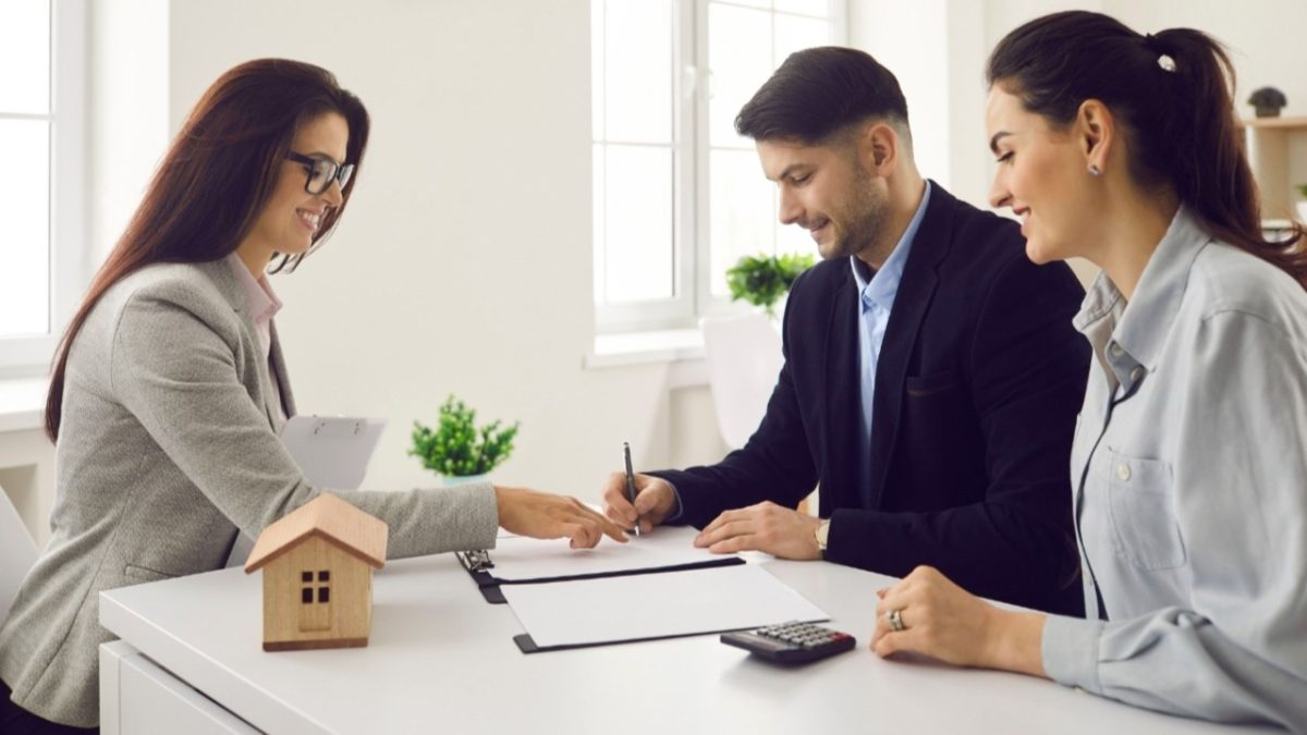 A global investor signing an off-plan property contract at a modern Dubai real estate office