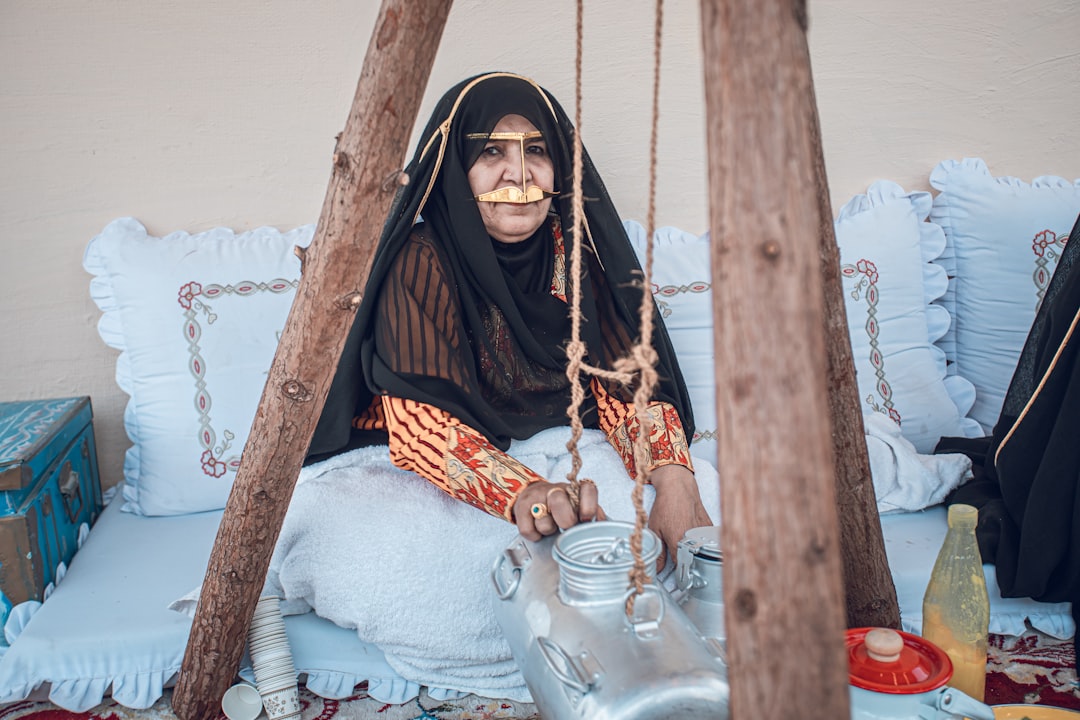 A woman enjoys a cup of gahwa in a traditional courtyard, a central ritual of Arabic culture in Dubai