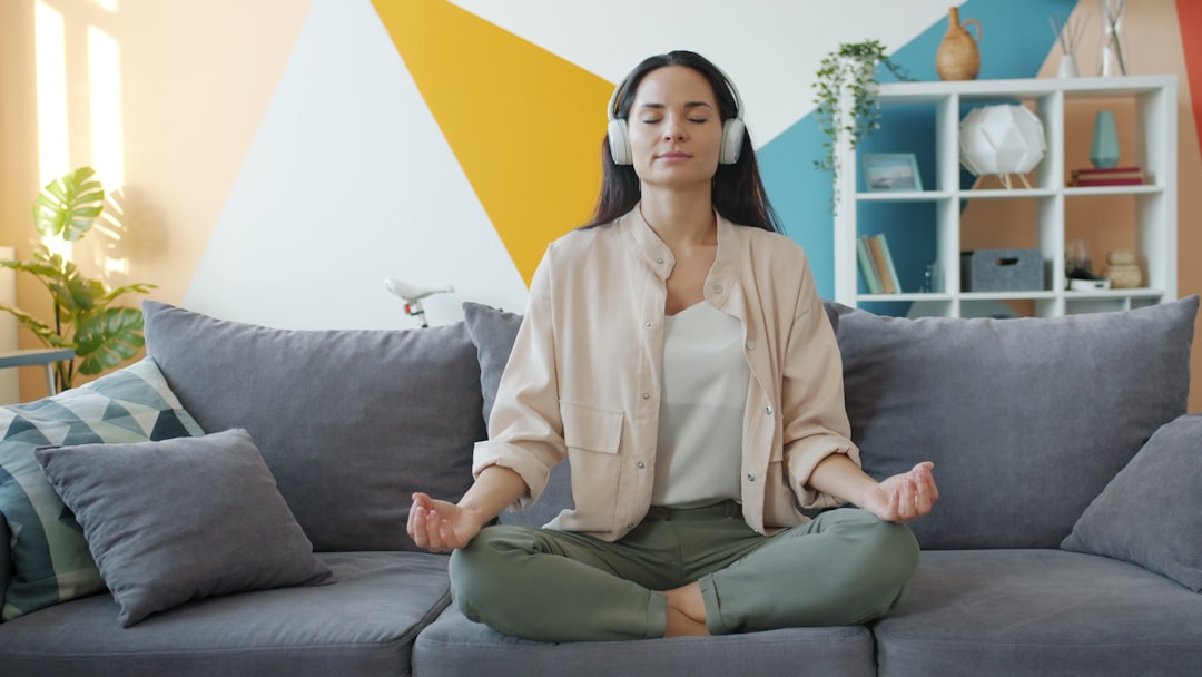 A woman practising morning meditation in her Dubai apartment, protecting her mental health during the summer.