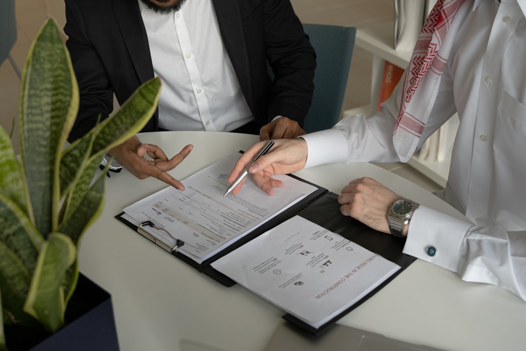 A business lawyer reviewing a commercial contract in a Dubai office, DIFC Courts support dispute resolution for investors
