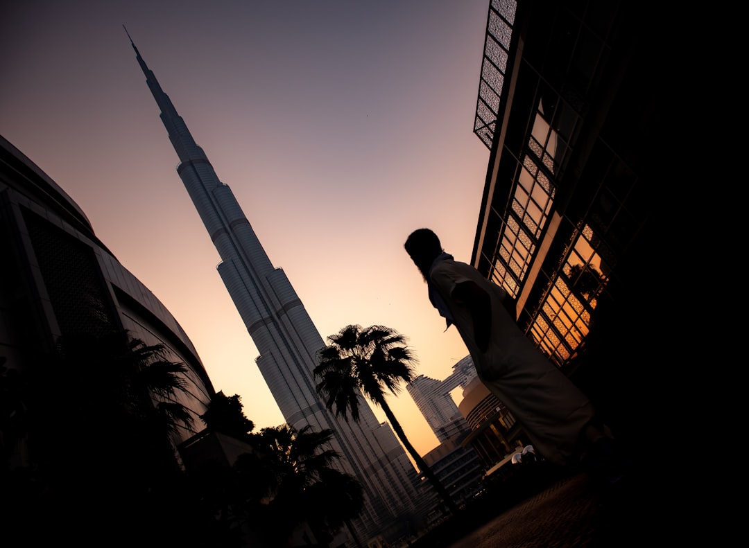 A Dubai investor reviewing a private equity deal agreement at a financial centre office