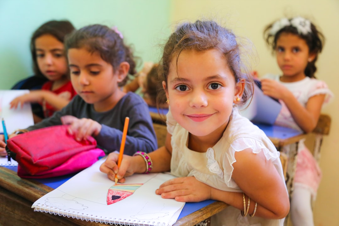 A mother helped her young child pack a school bag at home, preparing for the new school term in Dubai