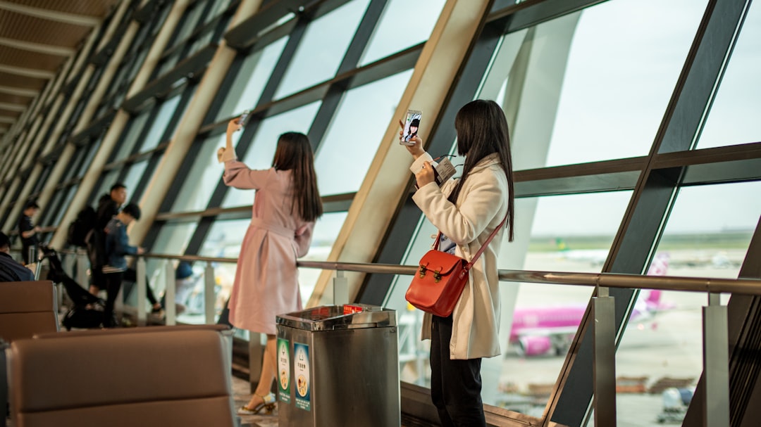 A traveler checking a boarding pass at a Dubai departure gate before flying one of the expanded Emirates routes