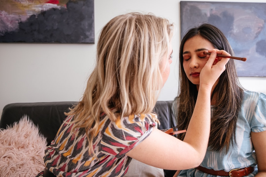 A woman applying mattifying primer as part of her humidity makeup routine in Dubai