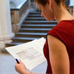 A professional investor reviews Dubai property market data and transaction reports at her desk