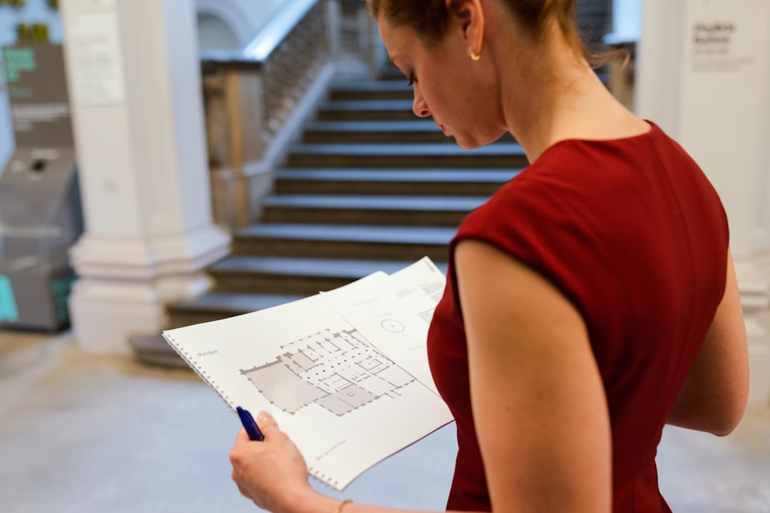 A professional investor reviews Dubai property market data and transaction reports at her desk