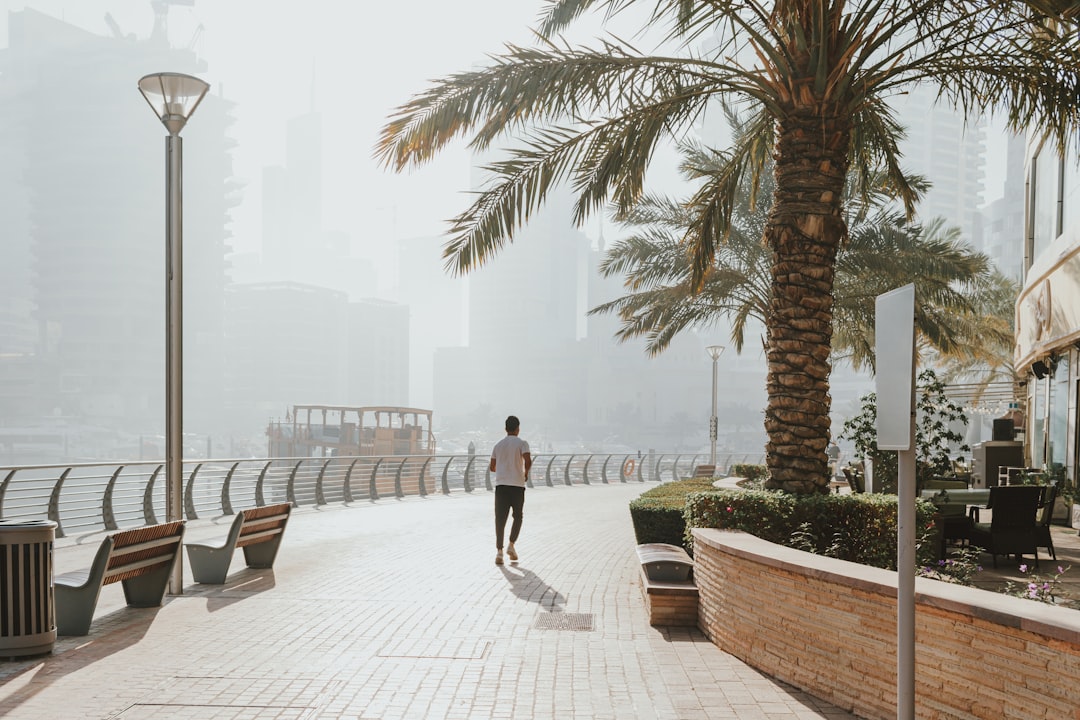 A woman running along Kite Beach in Dubai at sunrise as part of her seasonal fitness reset routine