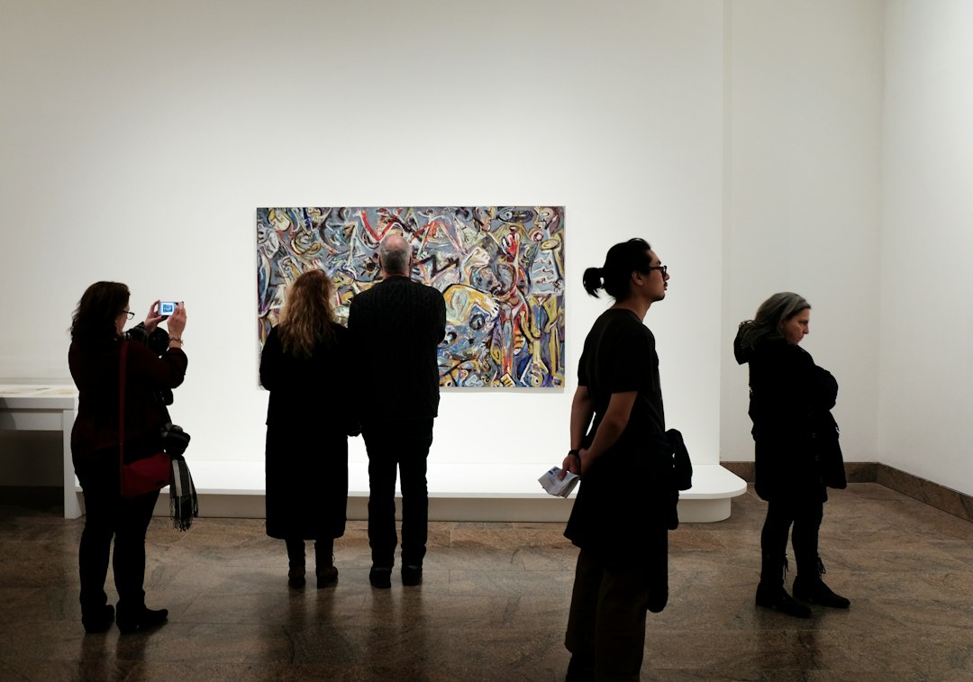 Visitor viewing art during the Sikka festival route in Al Fahidi